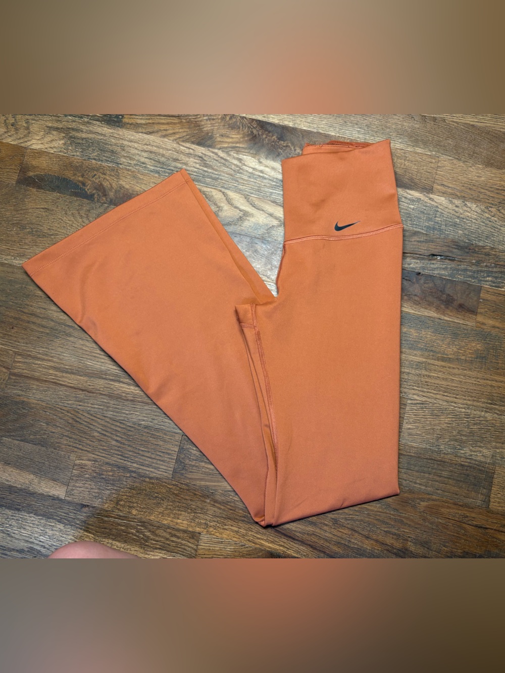 Nike Womenโs Orange Athletic Flared Leggings with Black Swoosh